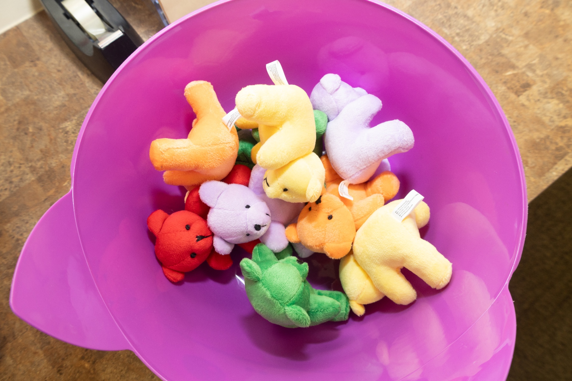 Bowl filled with small colourful plush toy animals